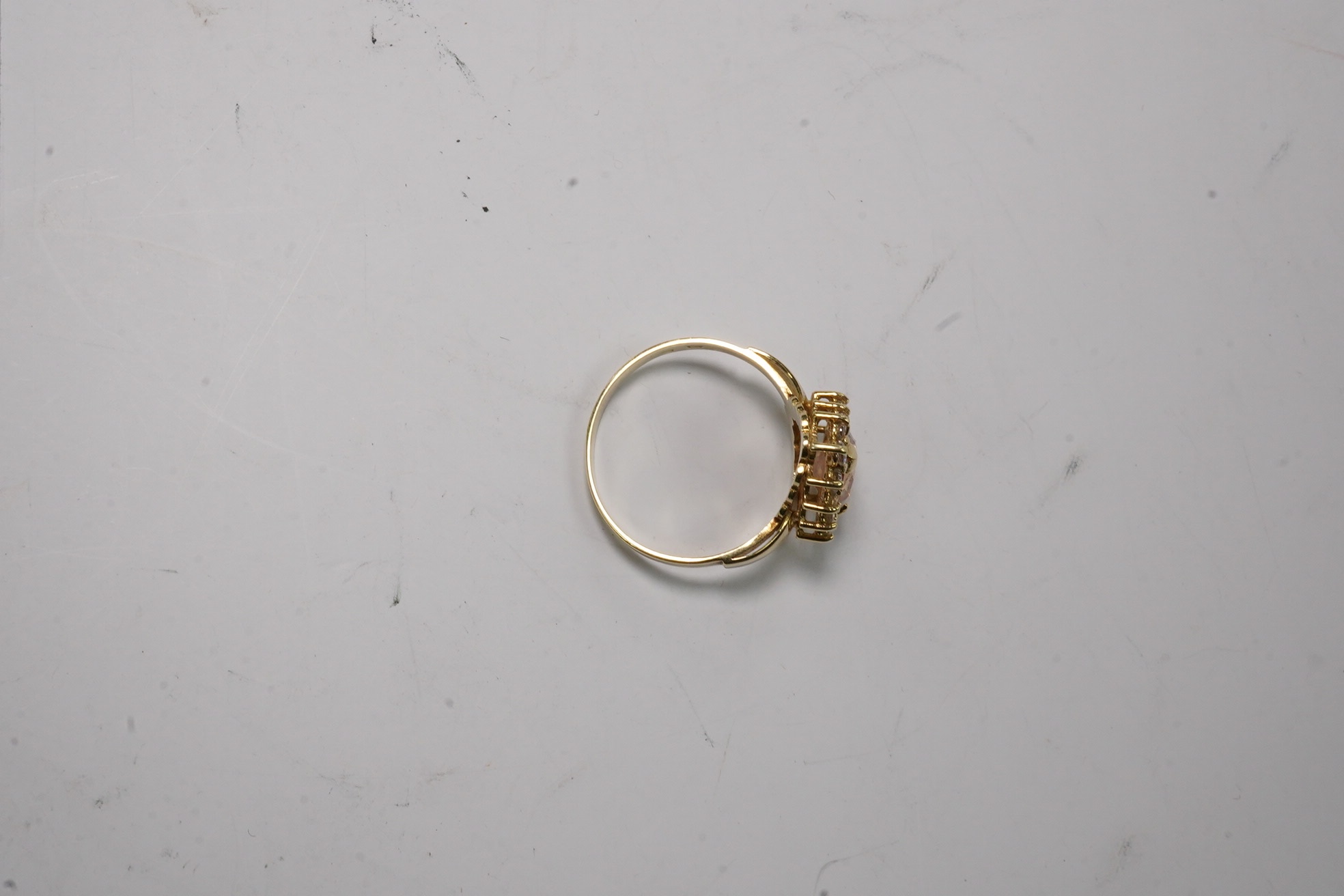 A 14k and simulated diamond set pear shaped cluster ring, size N, gross weight 3.8 grams. Condition - fair to good